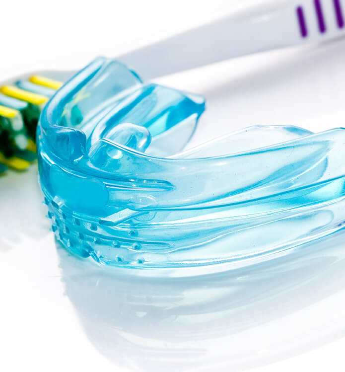 mouthguard next to a toothbrush