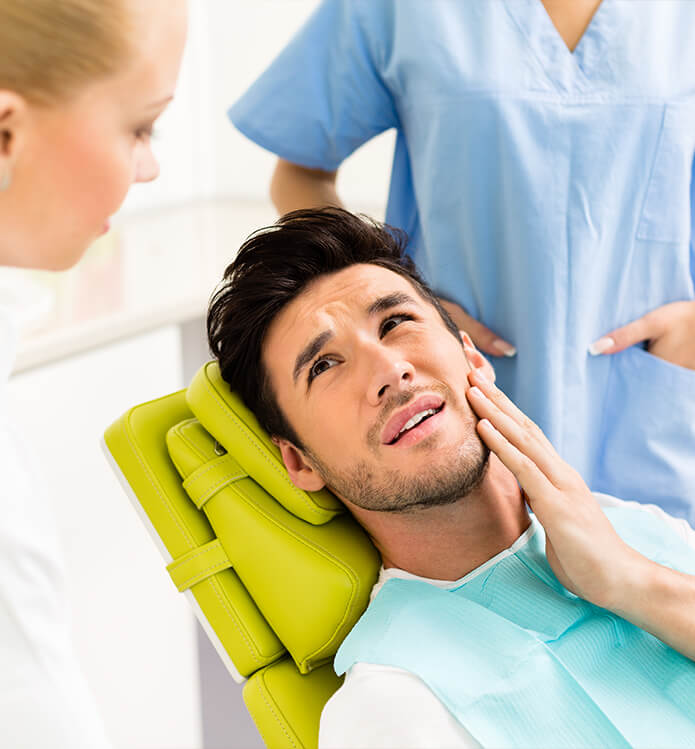 man holding his jaw in pain