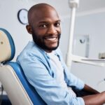 man sitting in dental chair